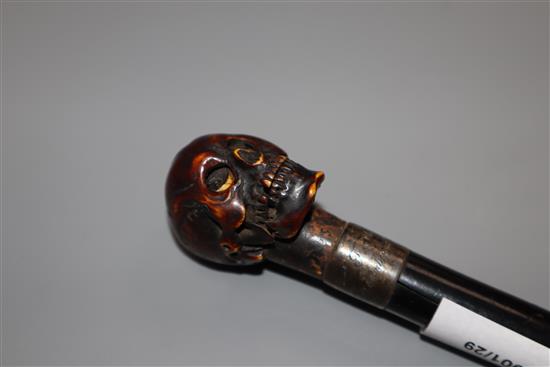 An ivory metamorphic skull cane handle, length 23.5cm